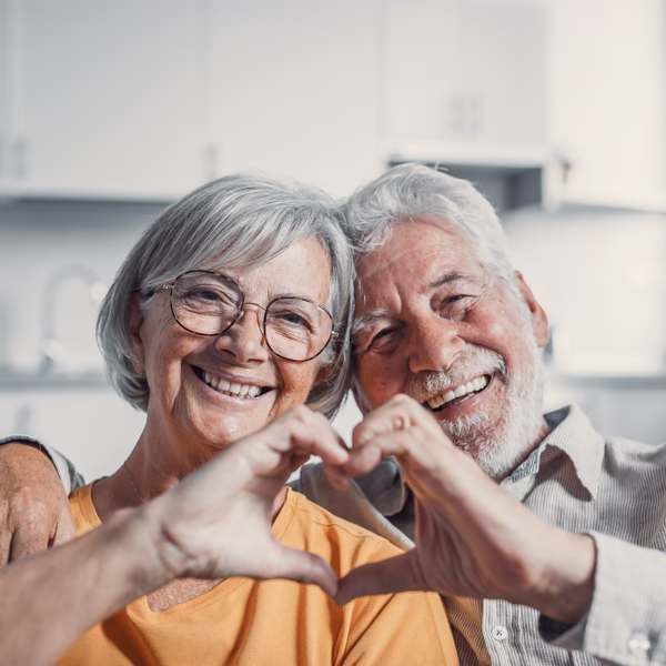 protesis-dentales-san-sebastian-de-los-reyes-600 Pareja mostrando sus prótesis dentales y formando un corazón con sus manos